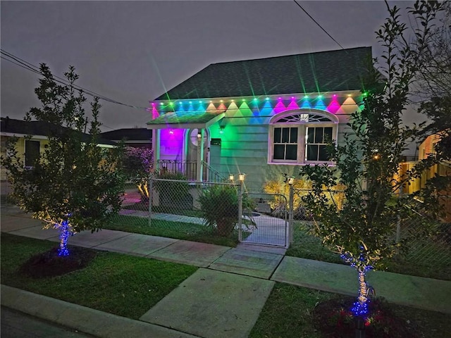 view of front facade featuring a fenced front yard and a gate