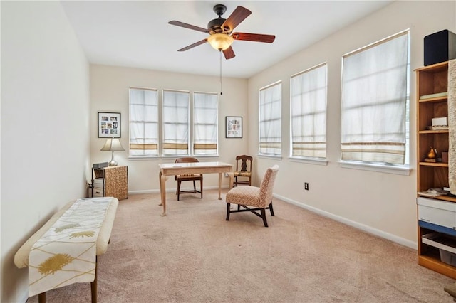 sitting room featuring a ceiling fan, carpet flooring, and baseboards