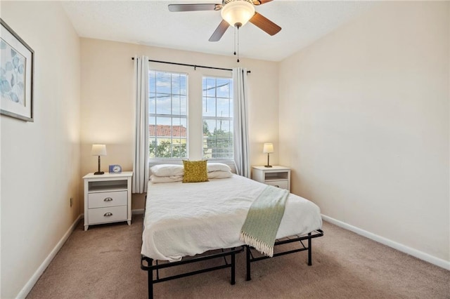 bedroom with carpet floors, baseboards, and a ceiling fan