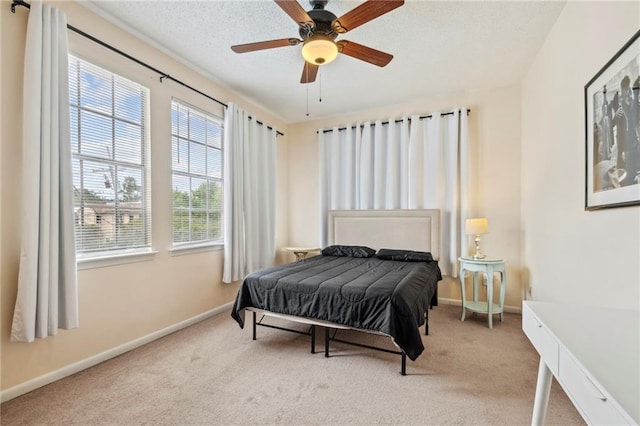 carpeted bedroom with baseboards and ceiling fan