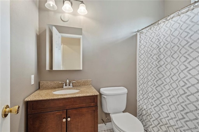 bathroom with toilet, vanity, and curtained shower