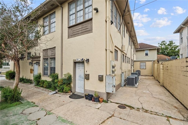 view of property featuring fence and central air condition unit