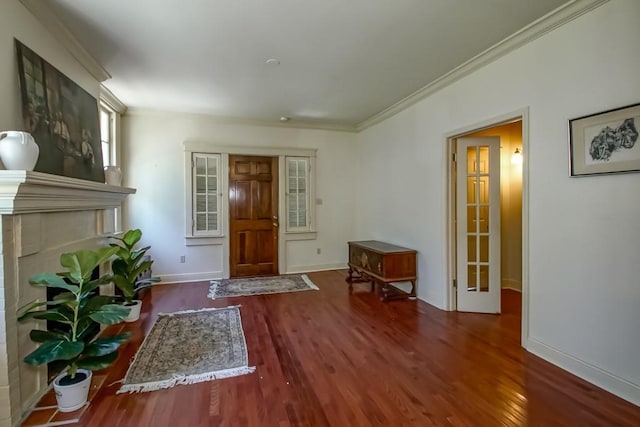 entrance foyer with crown molding, wood finished floors, and baseboards