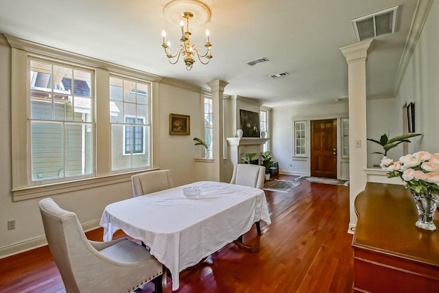 dining room with baseboards, visible vents, ornate columns, and dark wood-type flooring
