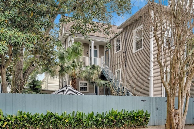 view of side of home featuring fence