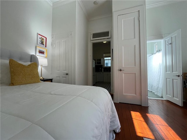 bedroom with crown molding and dark wood-style floors