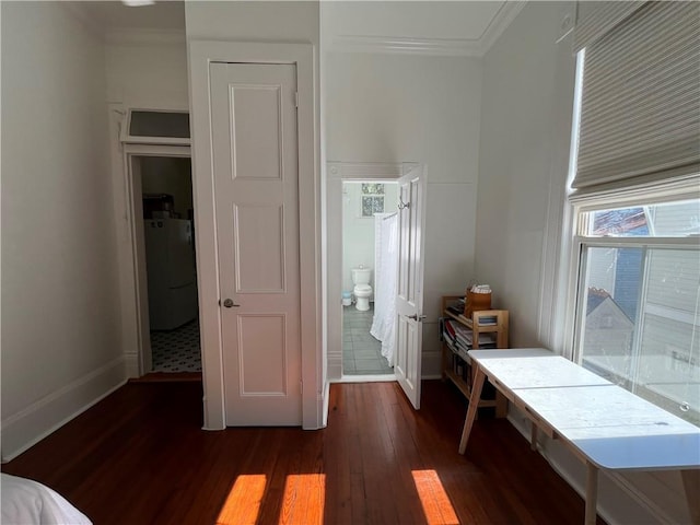 interior space with washer / clothes dryer, ornamental molding, dark wood-style flooring, and multiple windows