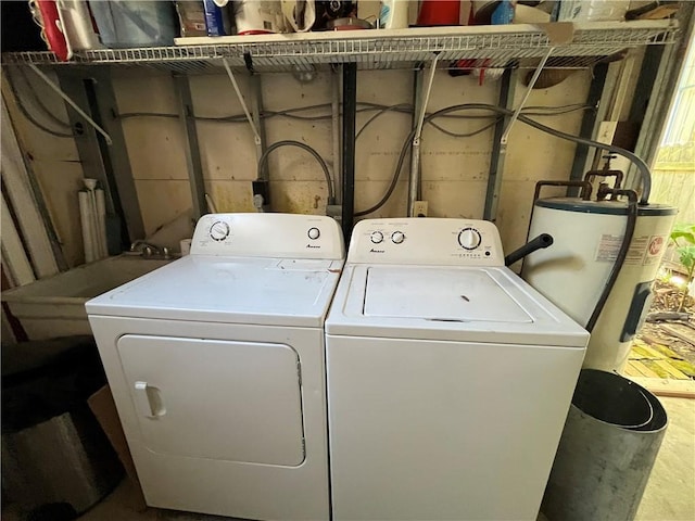 clothes washing area featuring laundry area, independent washer and dryer, and electric water heater