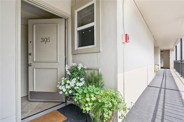 view of exterior entry featuring stucco siding