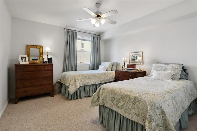 carpeted bedroom featuring baseboards and a ceiling fan