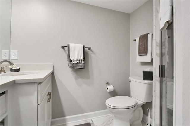full bathroom with toilet, baseboards, marble finish floor, and vanity