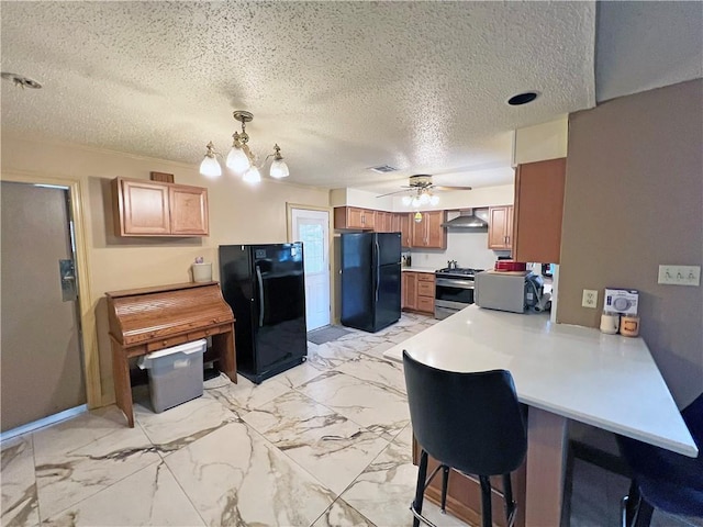 kitchen with freestanding refrigerator, light countertops, ventilation hood, and stainless steel range with gas cooktop