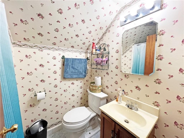 full bathroom with wallpapered walls, toilet, and vanity