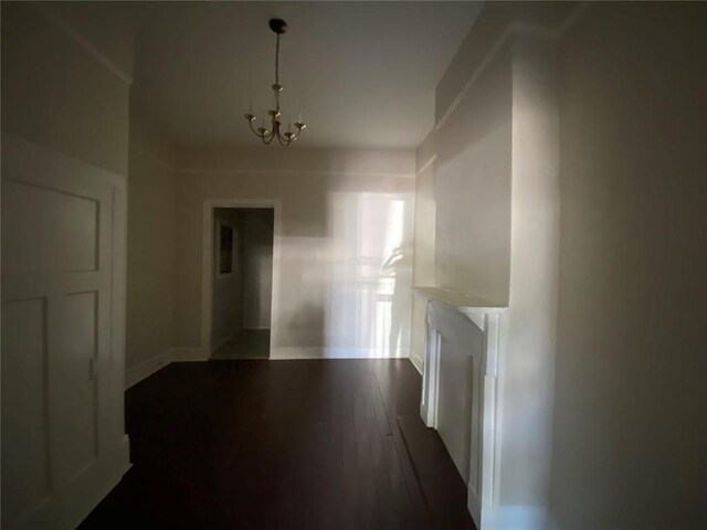 122628 Carondelet St, New Orleans, LA 70130 - hall featuring baseboards, a chandelier, and dark wood-type flooring