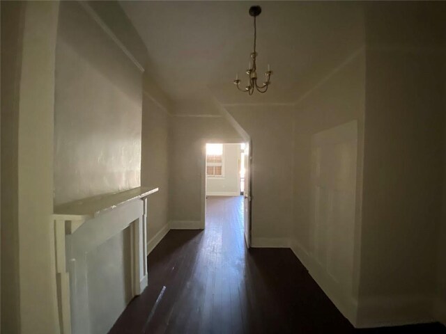 122628 Carondelet St, New Orleans, LA 70130 - additional living space with baseboards, a chandelier, and dark wood-type flooring
