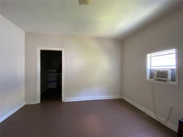 122628 Carondelet St, New Orleans, LA 70130 - empty room with baseboards, cooling unit, and concrete flooring