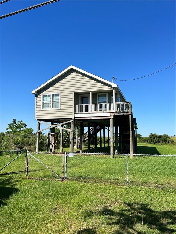 119 Carr Dr, Slidell, LA 70458 - rear view of property with a yard, stairway, and fence