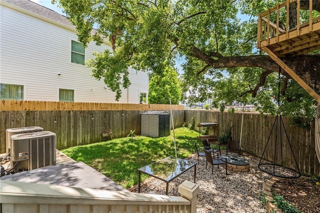 7468 Pitt St, New Orleans, LA 70118 - view of yard featuring central AC, a fenced backyard, and an outdoor fire pit