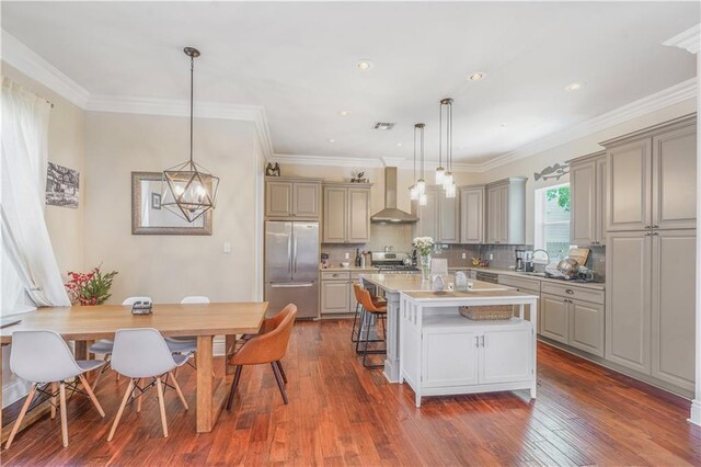 7468 Pitt St, New Orleans, LA 70118 - kitchen featuring wall chimney range hood, stainless steel appliances, and gray cabinetry