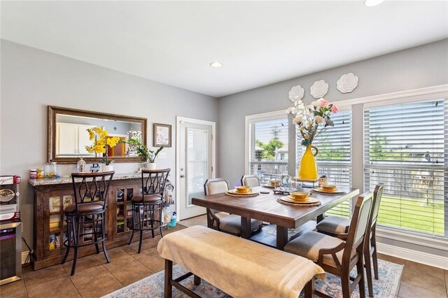 tiled dining room featuring recessed lighting and baseboards