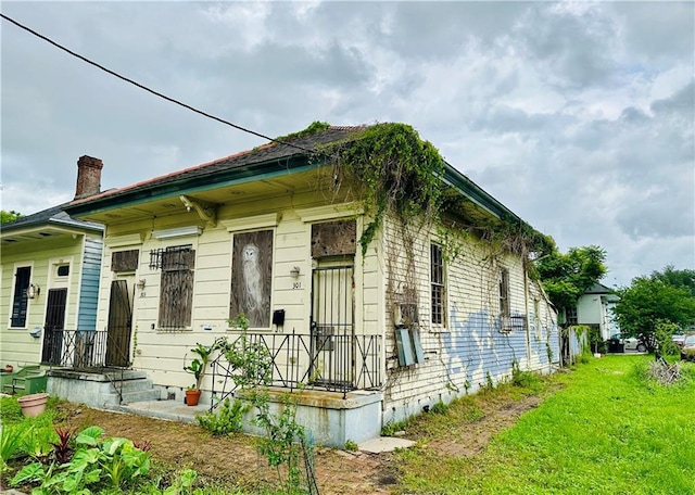 30103 Tricou St, New Orleans, LA 70117 - view of front of house with a chimney