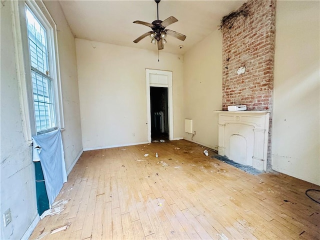 30103 Tricou St, New Orleans, LA 70117 - unfurnished room with baseboards, a healthy amount of sunlight, ceiling fan, and hardwood / wood-style flooring