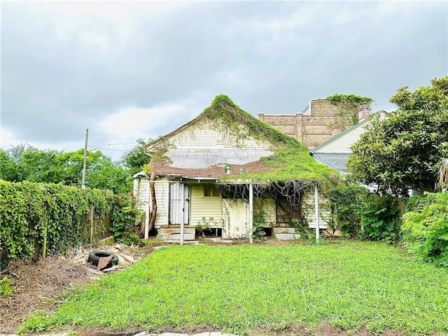 30103 Tricou St, New Orleans, LA 70117 - back of house featuring a yard, fence, and entry steps