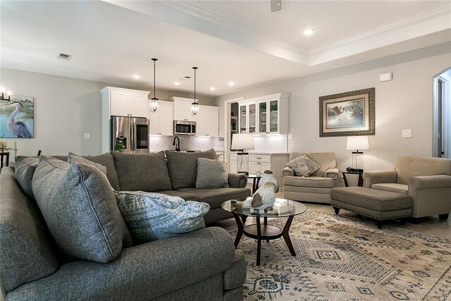 965 Kino St, Diamondhead, MS 39525 - living room featuring a ceiling fan, baseboards, ornamental molding, wood finished floors, and a raised ceiling
