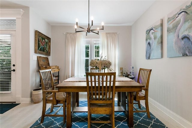 965 Kino St, Diamondhead, MS 39525 - kitchen with appliances with stainless steel finishes, a chandelier, tasteful backsplash, light wood-type flooring, and white cabinets
