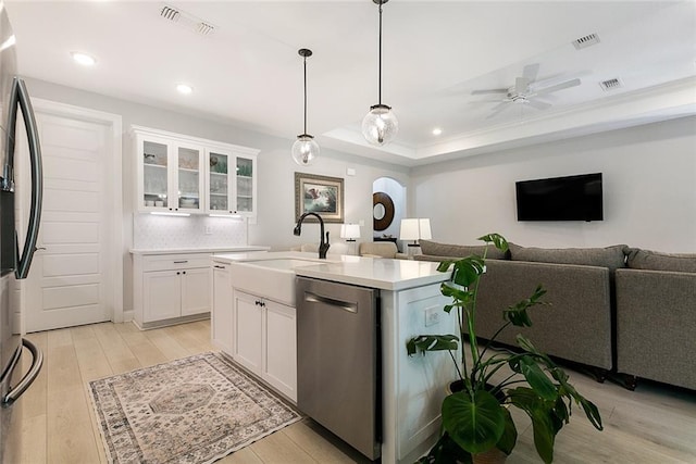 kitchen with appliances with stainless steel finishes, recessed lighting, white cabinets, light wood-style floors, and light countertops