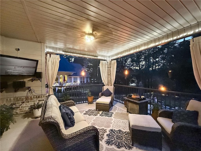patio at twilight featuring a balcony
