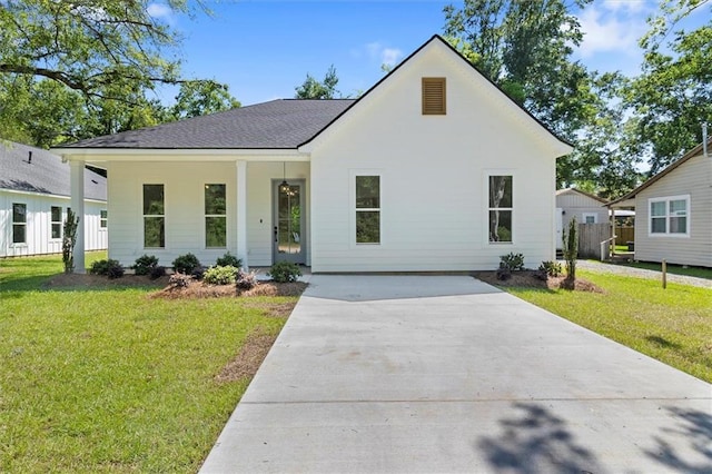309 W 27th Ave, Covington, LA 70433 - modern farmhouse style home with roof with shingles, concrete driveway, and a front yard