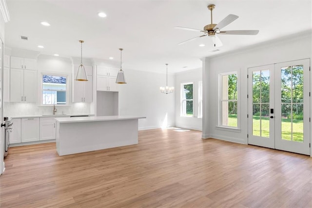 309 W 27th Ave, Covington, LA 70433 - kitchen with light wood finished floors, ornamental molding, and a healthy amount of sunlight