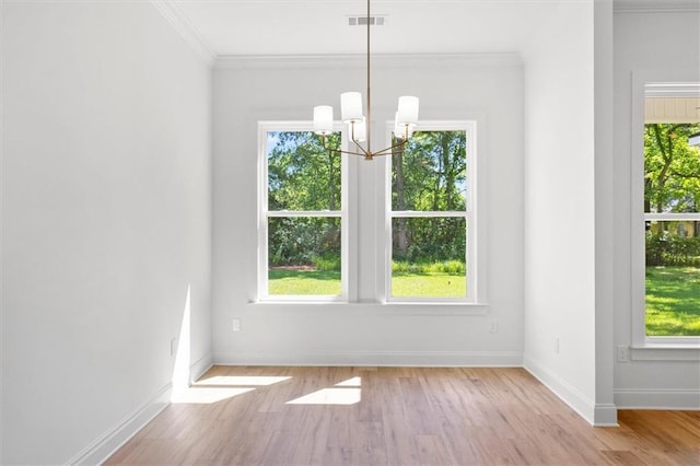 309 W 27th Ave, Covington, LA 70433 - unfurnished dining area with a wealth of natural light, a notable chandelier, baseboards, and visible vents