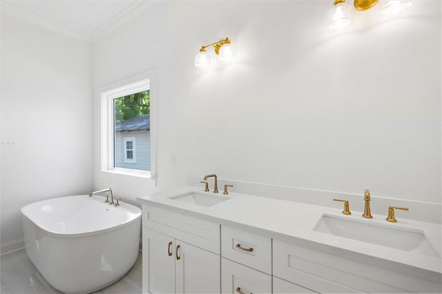 309 W 27th Ave, Covington, LA 70433 - full bathroom with ornamental molding, a freestanding bath, a sink, and double vanity