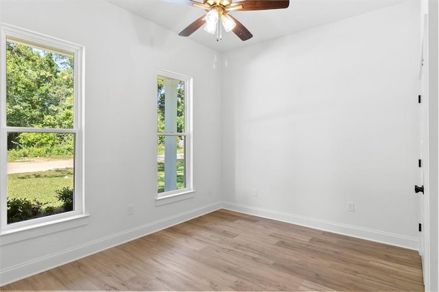 309 W 27th Ave, Covington, LA 70433 - empty room with baseboards, a healthy amount of sunlight, light wood-style flooring, and a ceiling fan