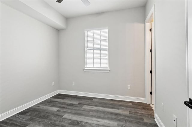 unfurnished room with dark wood-type flooring, baseboards, and a ceiling fan