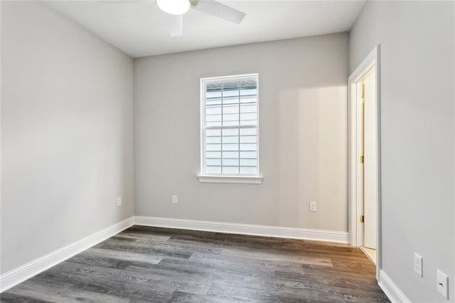 spare room with baseboards, a ceiling fan, and wood finished floors