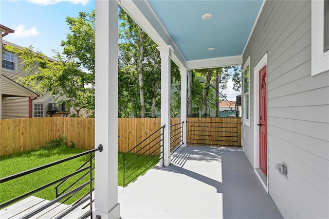 view of patio / terrace featuring covered porch and fence