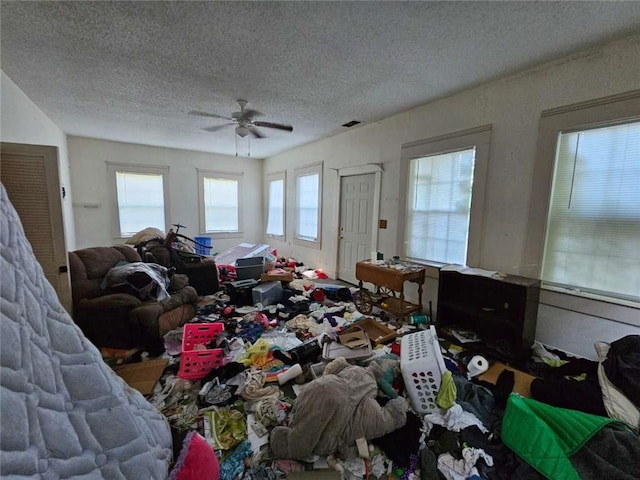 miscellaneous room with a ceiling fan, visible vents, and a textured ceiling