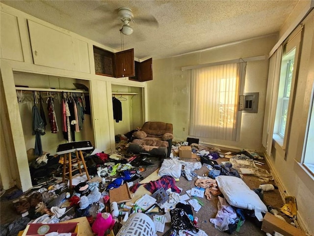 miscellaneous room featuring ceiling fan and a textured ceiling