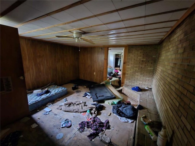 interior space with wood walls and brick wall