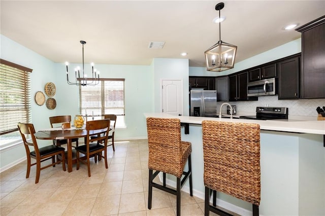 kitchen featuring a chandelier, a healthy amount of sunlight, and appliances with stainless steel finishes