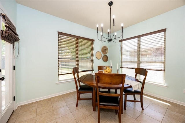 dining room featuring a wealth of natural light, a notable chandelier, and light tile patterned floors