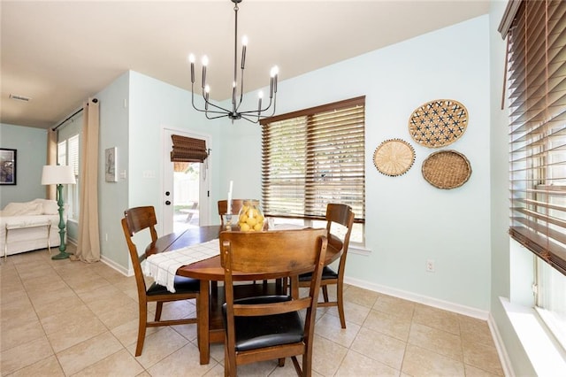 dining area with a notable chandelier, a healthy amount of sunlight, light tile patterned flooring, and visible vents