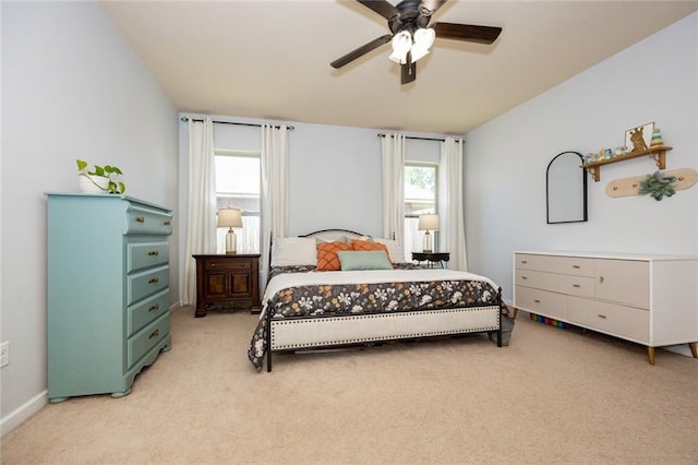 bedroom with light carpet and a ceiling fan