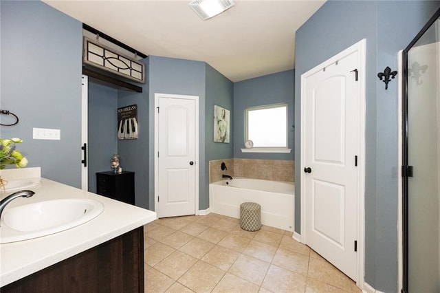 bathroom featuring visible vents, a bath, a sink, tile patterned floors, and double vanity