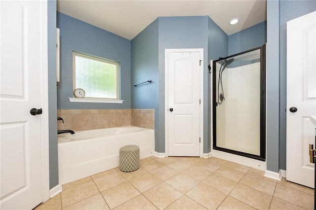 full bath with tile patterned floors, a garden tub, baseboards, and a stall shower