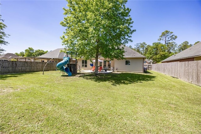 view of yard featuring a playground, a patio area, and a fenced backyard