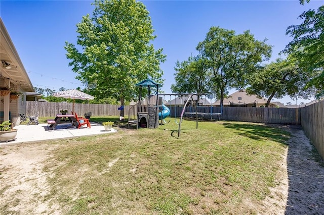 view of yard with a playground, a patio area, and a fenced backyard